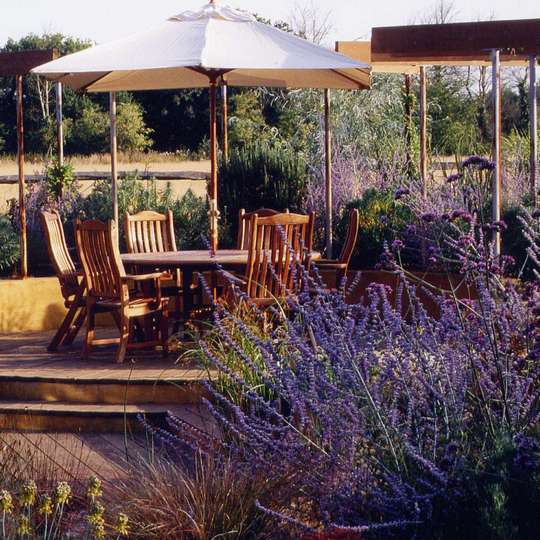 An outdoor room surrounded by raised beds